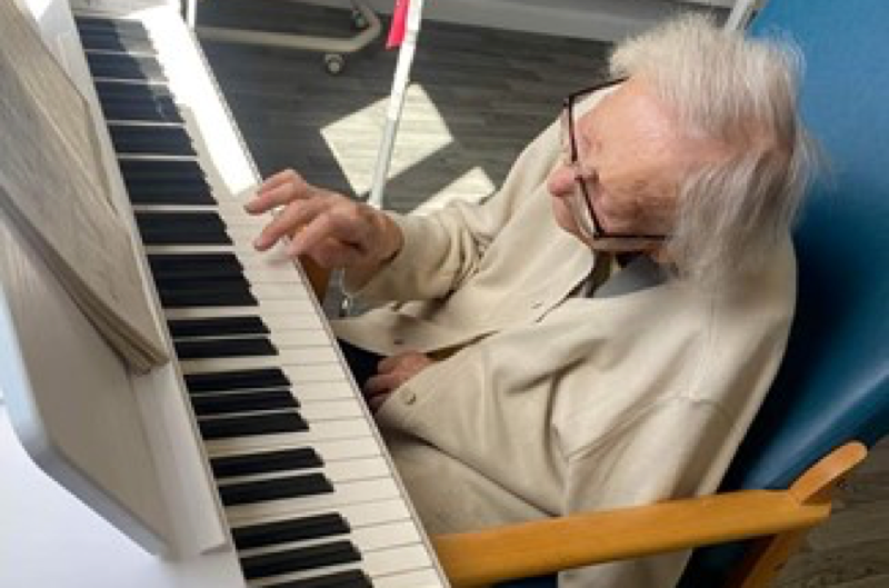 Elderly person playing the piano